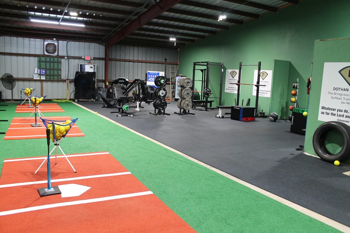 The weight and conditioning area with squat racks, plates, and training equipment