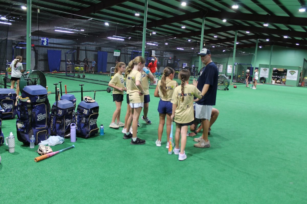 A Fury team gathered around their coach during an indoor practice