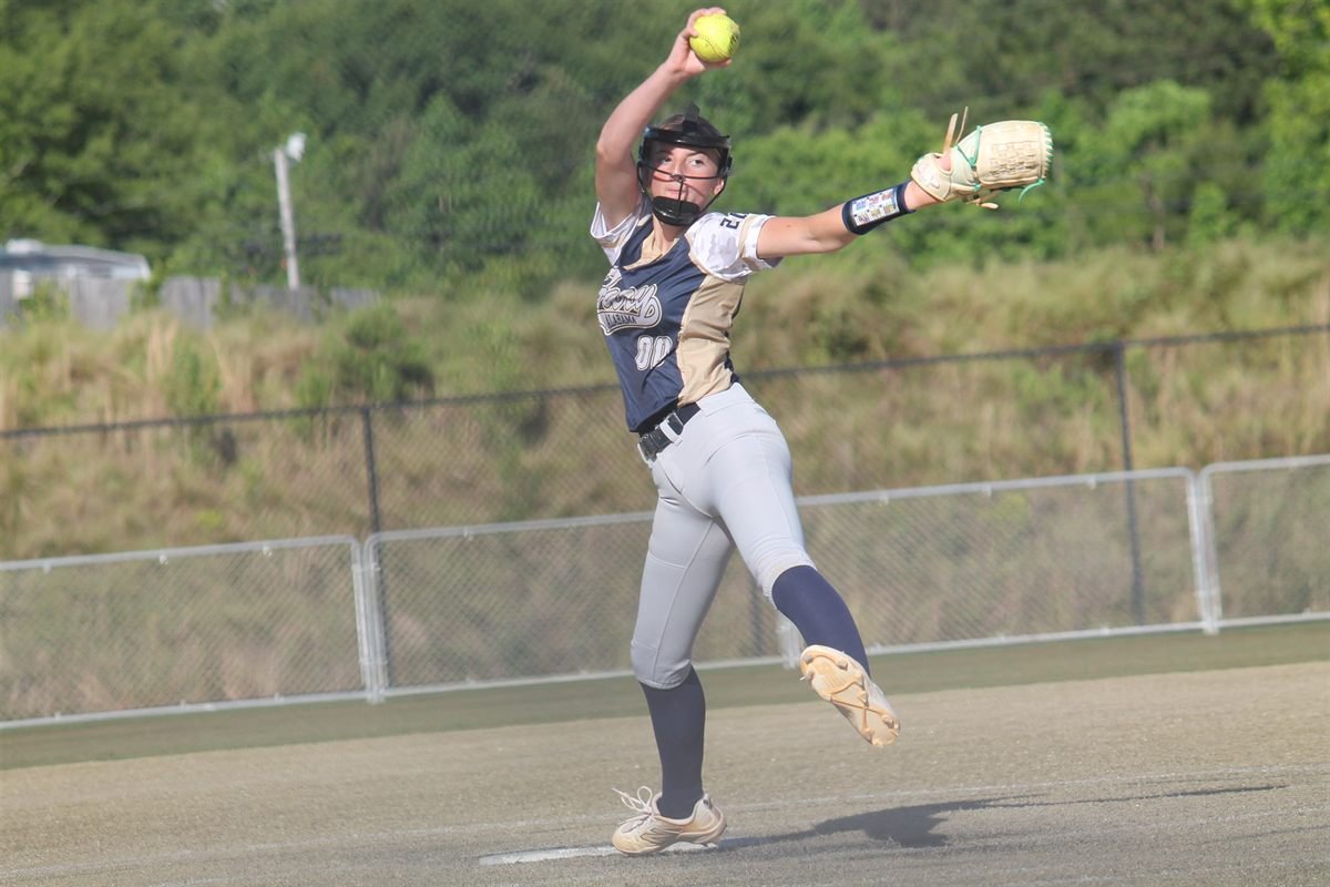 A Fury infielder mid-stride, throwing across the diamond with the ball just out of her hand