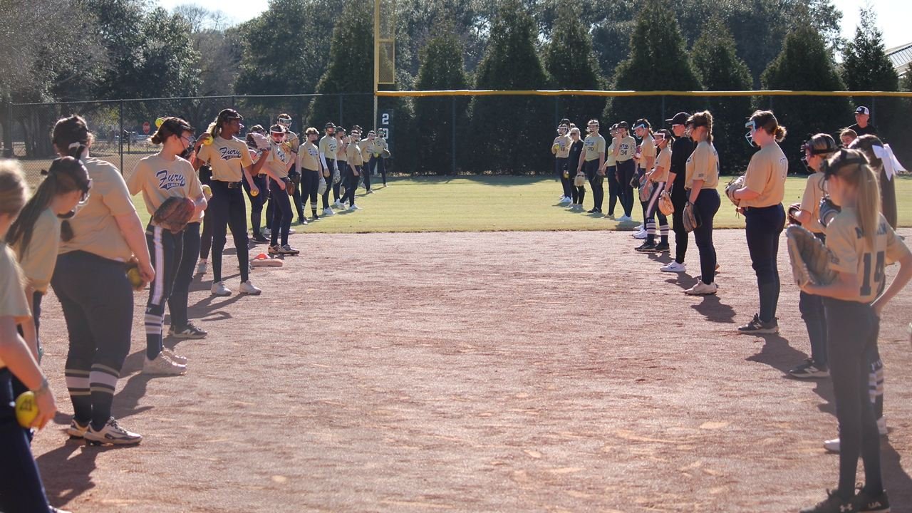 Two lines of Alabama Fury players facing each other down the length of the infield