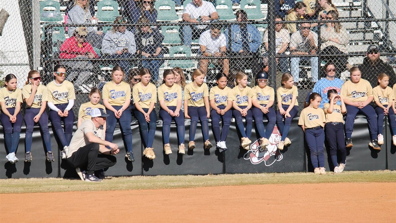 Fury teams from several age groups lined up along the dugout fence